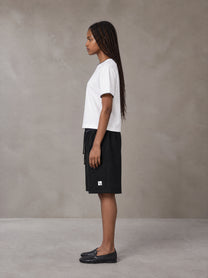 Model wearing SM Plaid Shorts in Midnight Black, side view.