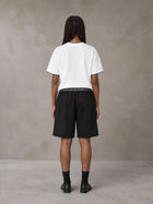 Model wearing SM Plaid Shorts in Midnight Black, rear view.