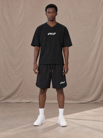 Model wearing SM Motion T-shirt in Midnight Black with SM Motion Oversized Court Shorts in Midnight Black, front view.