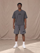 Model wearing SM Motion T-shirt in Deep Charcoal with SM Motion Oversized Court Shorts in Deep Charcoal, front view.