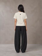 Model wearing SM Sig. Henley T-shirt in Oat Grey, rear view.