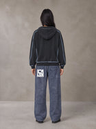 Model wearing SM Acid Wash Trousers in Deep Denim, rear view.