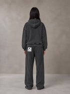 Model wearing the SM Arc Hoodie and SM Arc Sweatpants in Midnight Black, rear view.