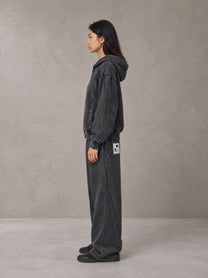 Model wearing the SM Arc Hoodie and SM Arc Sweatpants in Midnight Black, side profile.