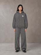 Model wearing the SM Arc Hoodie and SM Arc Sweatpants in Deep Charcoal, front view.