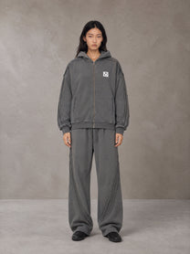 Model wearing the SM Arc Hoodie and SM Arc Sweatpants in Deep Charcoal, front view.