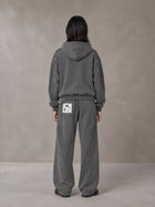 Model wearing the SM Arc Hoodie and SM Arc Sweatpants in Deep Charcoal, rear view.