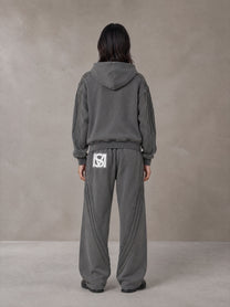 Model wearing the SM Arc Hoodie and SM Arc Sweatpants in Deep Charcoal, rear view.