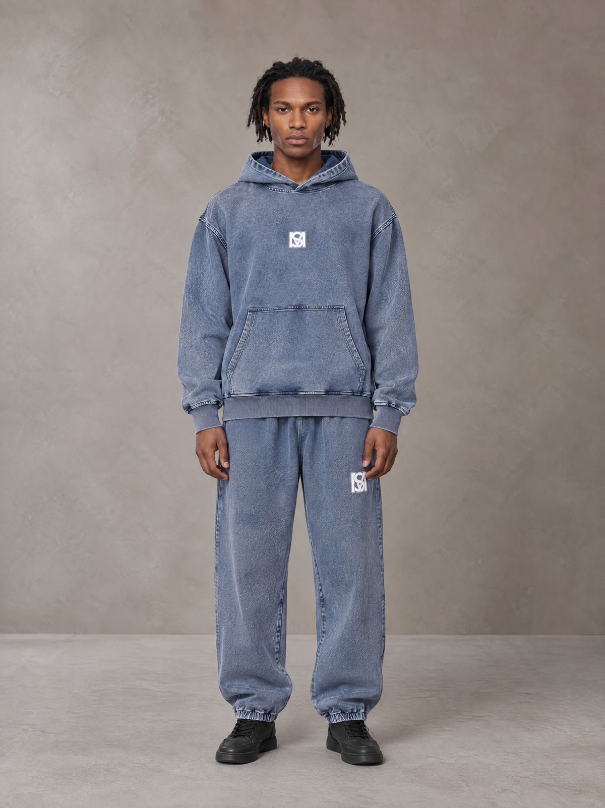 Model wearing the SM Denim Wash Hoodie and SM Denim Wash Sweatpants in Chambray, front view.