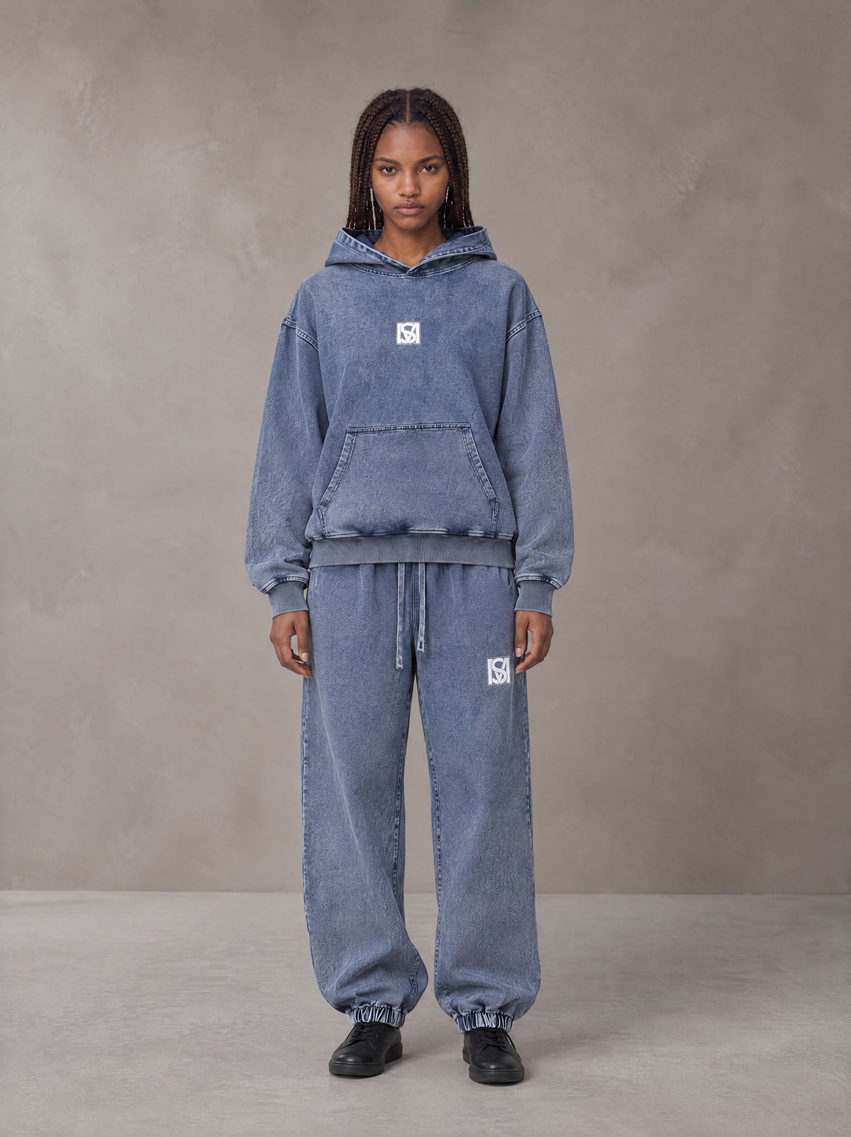 Model wearing the SM Denim Wash Hoodie and SM Denim Wash Sweatpants in Chambray, front view.