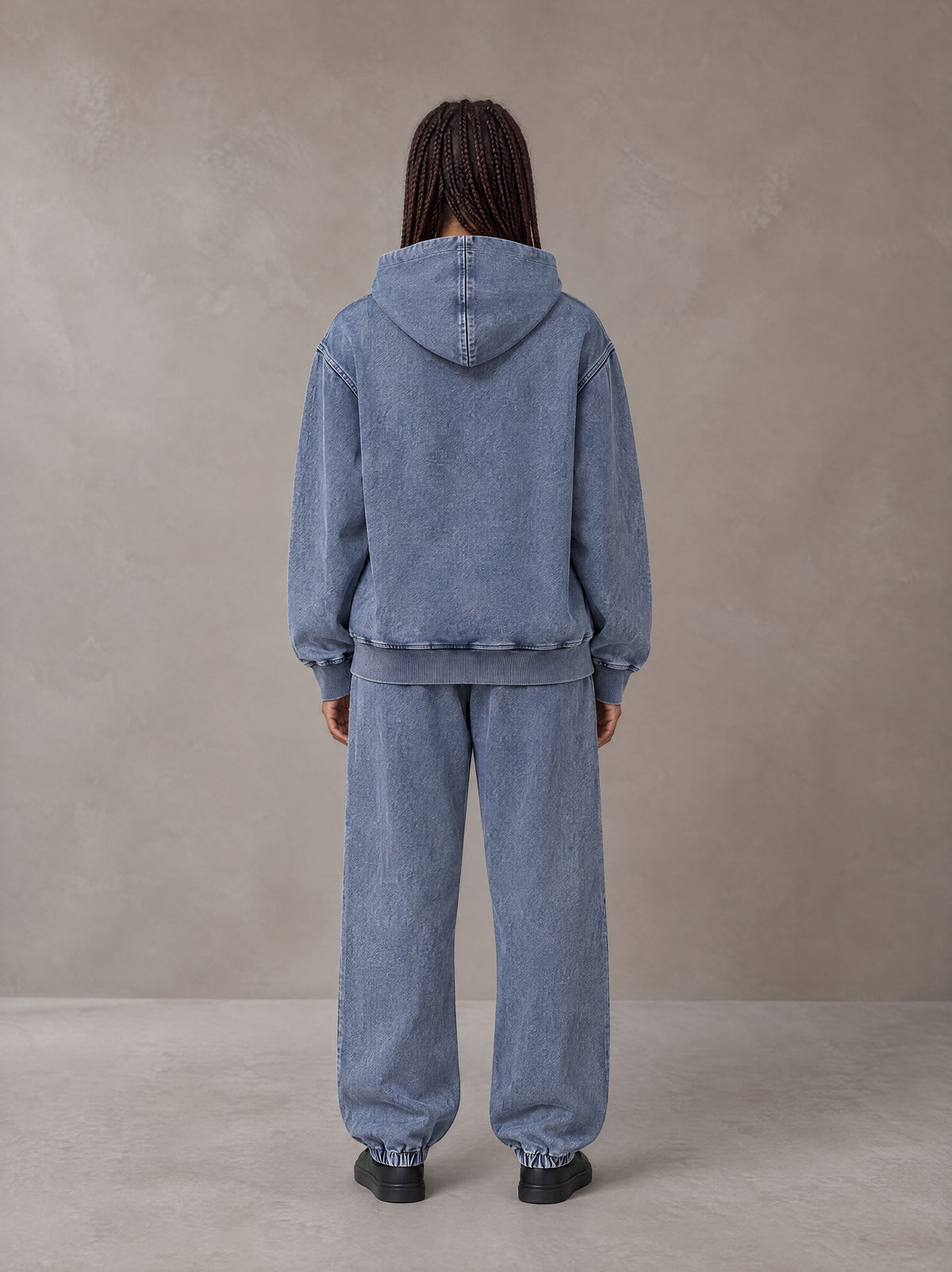 Model wearing the SM Denim Wash Hoodie and SM Denim Wash Sweatpants in Chambray, rear view.