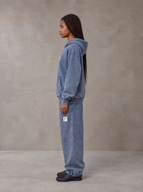 Model wearing the SM Denim Wash Hoodie and SM Denim Wash Sweatpants in Chambray, side profile.