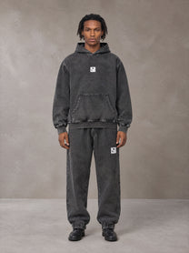 Model wearing the SM Denim Wash Hoodie and SM Denim Wash Sweatpants in Midnight Black, front view.