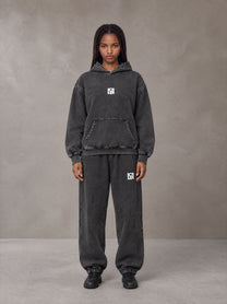 Model wearing the SM Denim Wash Hoodie and SM Denim Wash Sweatpants in Midnight Black, front view.
