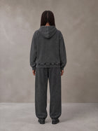 Model wearing the SM Denim Wash Hoodie and SM Denim Wash Sweatpants in Midnight Black, rear view.