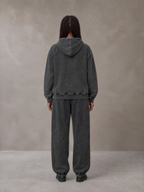 Model wearing the SM Denim Wash Hoodie and SM Denim Wash Sweatpants in Midnight Black, rear view.