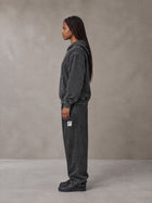 Model wearing the SM Denim Wash Hoodie and SM Denim Wash Sweatpants in Midnight Black, side profile.