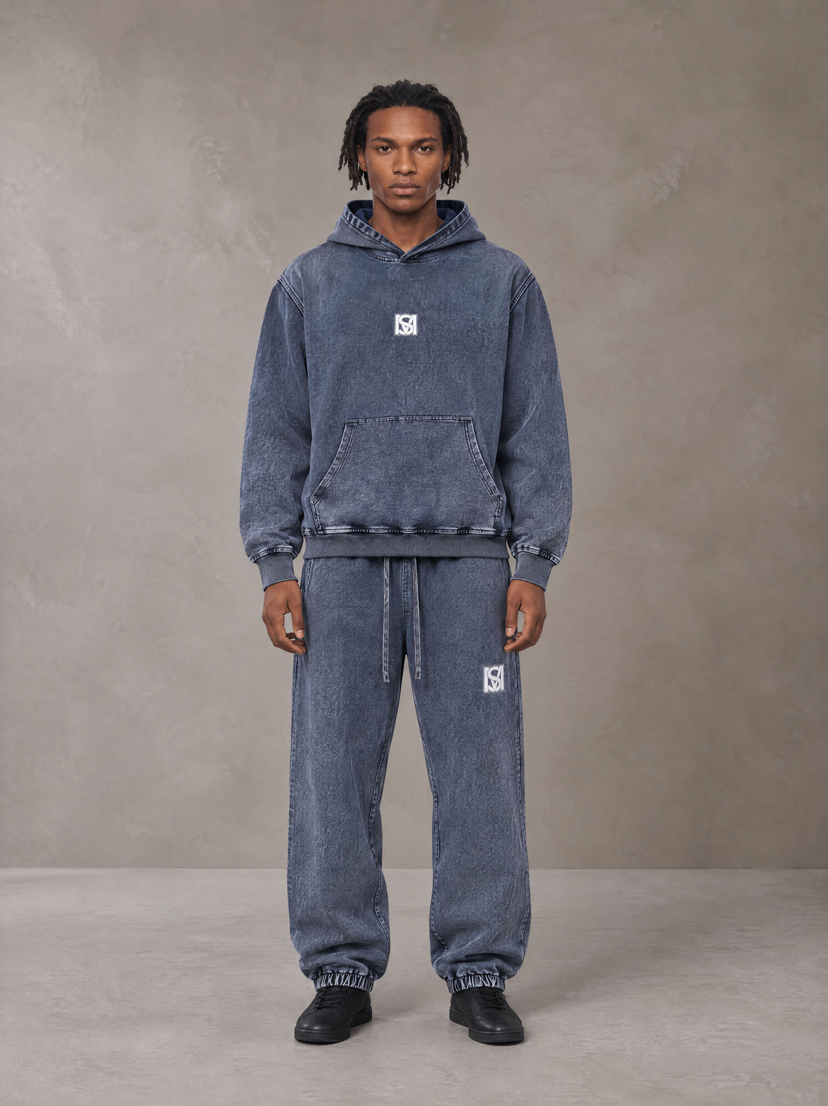 Model wearing the SM Denim Wash Hoodie and SM Denim Wash Sweatpants in Oxford Navy, front view.