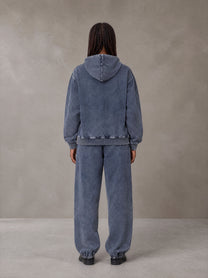 Model wearing the SM Denim Wash Hoodie and SM Denim Wash Sweatpants in Oxford Navy, rear view.