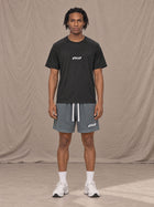 Model wearing the SM Motion Mesh Shorts in Ashen Grey, front view.