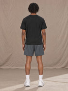 Model wearing the SM Motion Mesh Shorts in Ashen Grey, rear view.