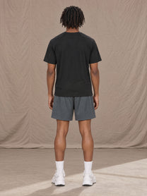 Model wearing the SM Motion Mesh Shorts in Ashen Grey, rear view.