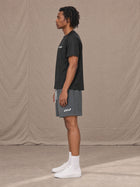 Model wearing the SM Motion Mesh Shorts in Ashen Grey, side profile.