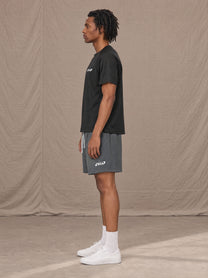 Model wearing the SM Motion Mesh Shorts in Ashen Grey, side profile.