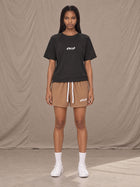 Model wearing the SM Motion Mesh Shorts in French Beige, front view.