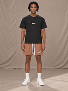 Model wearing the SM Motion Mesh Shorts in French Beige, front view.