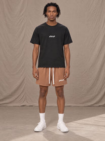 Model wearing the SM Motion Mesh Shorts in French Beige, front view.