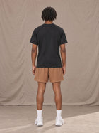 Model wearing the SM Motion Mesh Shorts in French Beige, rear view.