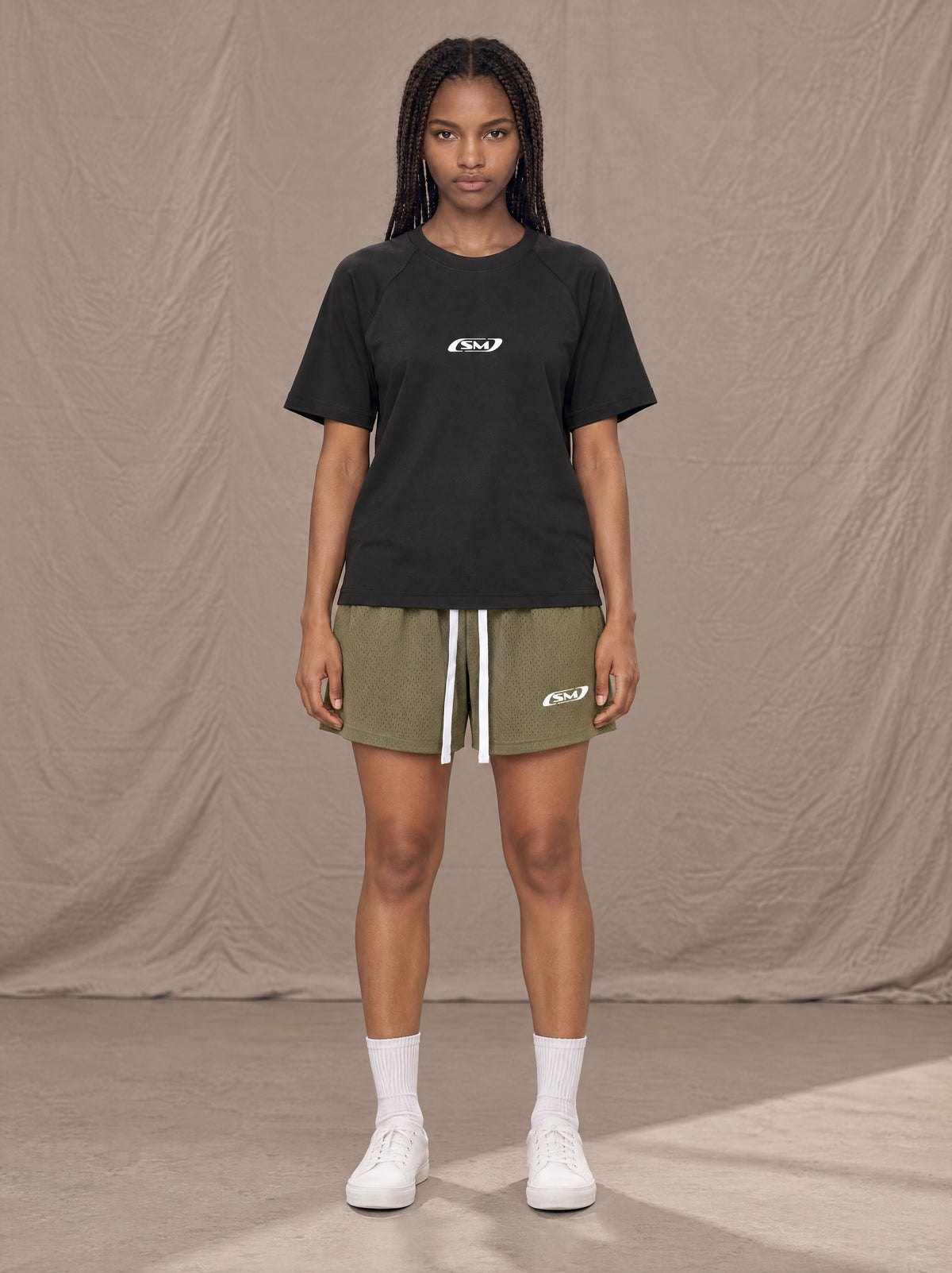 Model wearing the SM Motion Mesh Shorts in Heritage Khaki, front view.