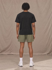 Model wearing the SM Motion Mesh Shorts in Heritage Khaki, rear view.
