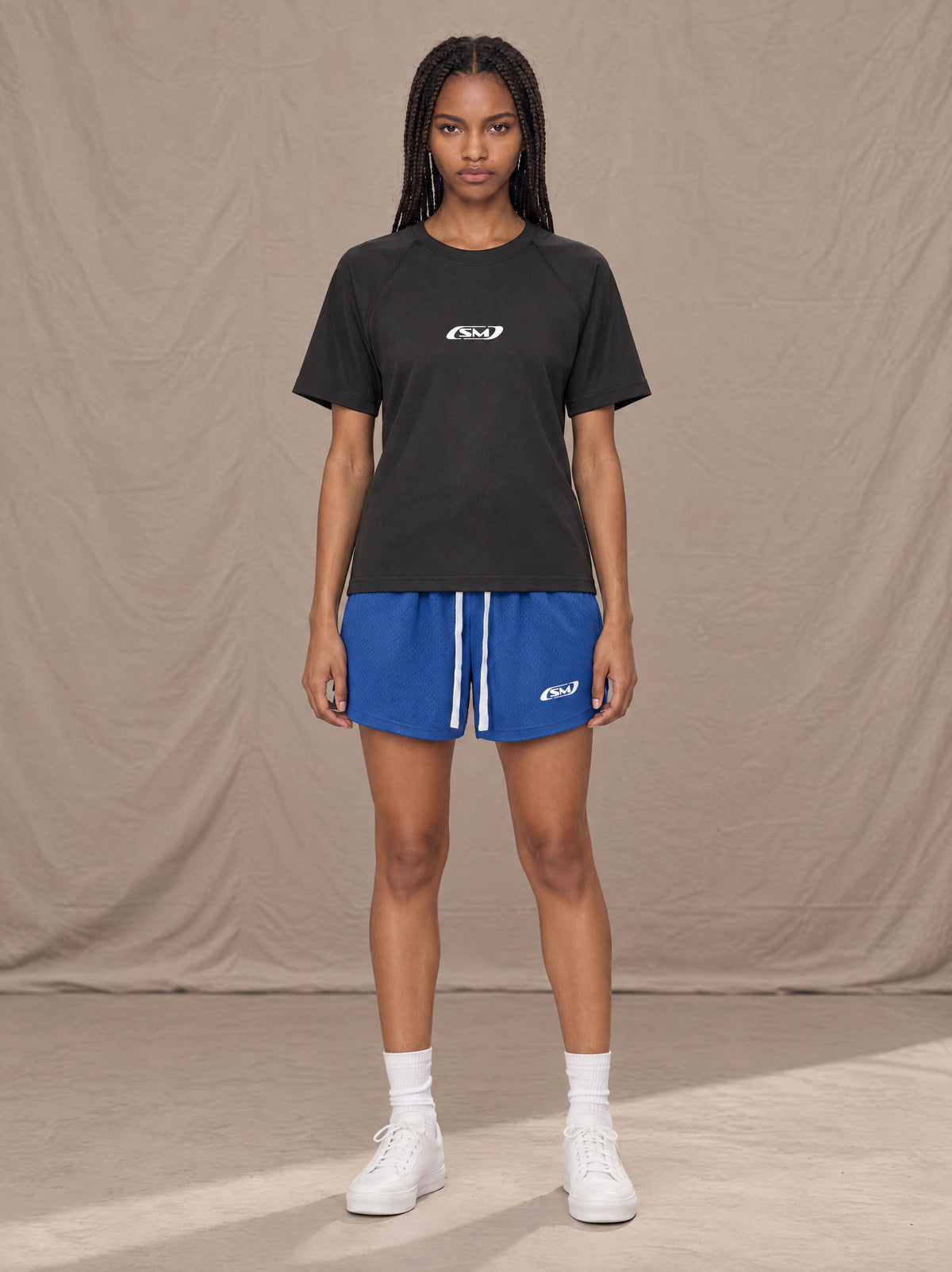 Model wearing the SM Motion Mesh Shorts in Klein Blue, front view.