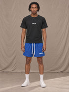 Model wearing the SM Motion Mesh Shorts in Klein Blue, front view.