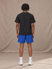 Model wearing the SM Motion Mesh Shorts in Klein Blue, rear view.