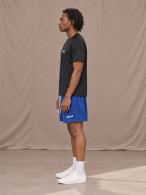 Model wearing the SM Motion Mesh Shorts in Klein Blue, side profile.