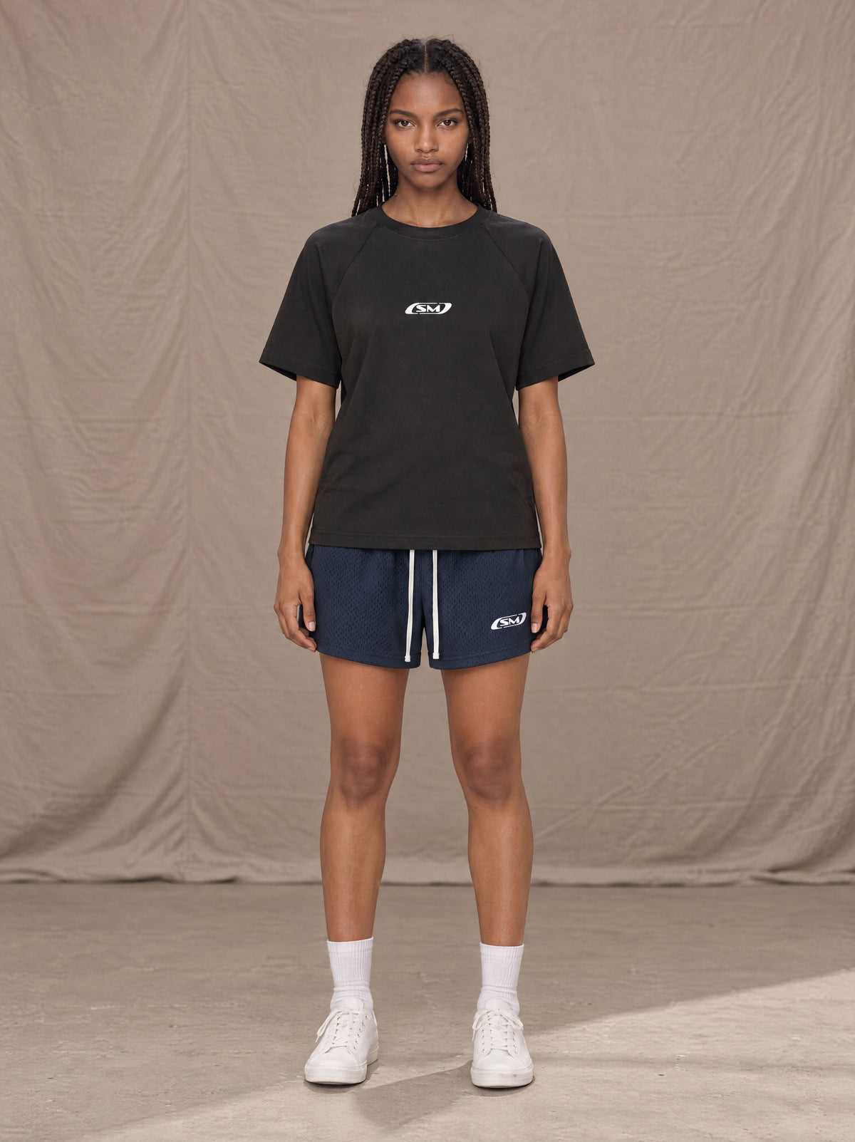 Model wearing the SM Motion Mesh Shorts in Oxford Navy, front view.
