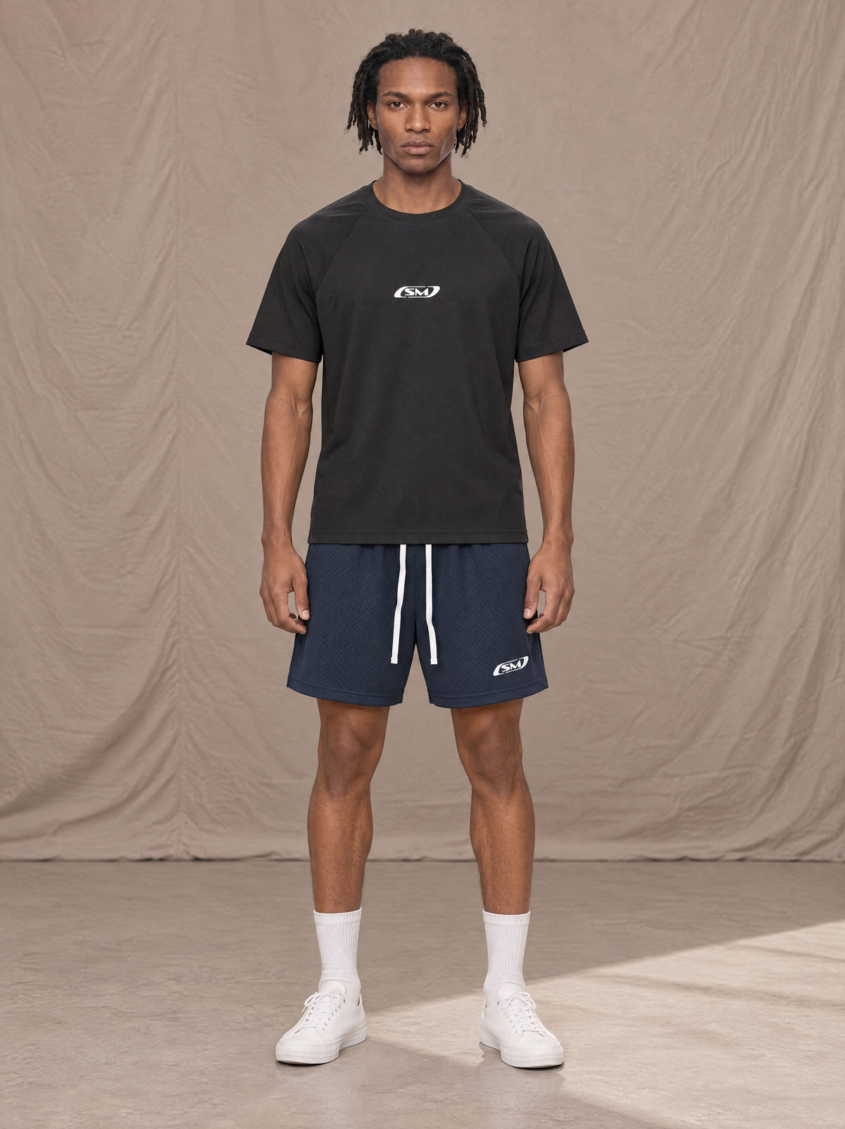 Model wearing the SM Motion Mesh Shorts in Oxford Navy, front view.