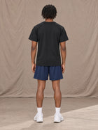Model wearing the SM Motion Mesh Shorts in Oxford Navy, rear view.