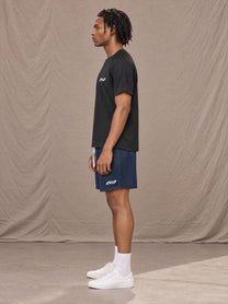 Model wearing the SM Motion Mesh Shorts in Oxford Navy, side profile.