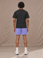 Model wearing the SM Motion Mesh Shorts in Pastel Violet, rear view.