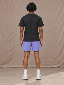Model wearing the SM Motion Mesh Shorts in Pastel Violet, rear view.