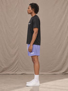 Model wearing the SM Motion Mesh Shorts in Pastel Violet, side profile.