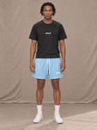 Model wearing the SM Motion Mesh Shorts in Sky Tint, front view.