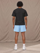 Model wearing the SM Motion Mesh Shorts in Sky Tint, rear view.