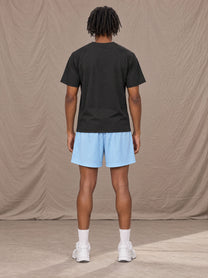 Model wearing the SM Motion Mesh Shorts in Sky Tint, rear view.