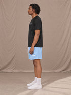 Model wearing the SM Motion Mesh Shorts in Sky Tint, side profile.