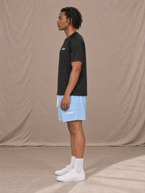 Model wearing the SM Motion Mesh Shorts in Sky Tint, side profile.